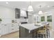 Modern kitchen with a large island, pendant lighting, and sleek white cabinetry at 731 38Th N Ave, St Petersburg, FL 33704