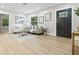 Bright living room features modern decor, wood floors, and a stylish front door at 731 38Th N Ave, St Petersburg, FL 33704