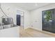 Utility room with a laundry sink, black door, and access to storage and the backyard at 731 38Th N Ave, St Petersburg, FL 33704
