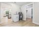 Utility room equipped with a laundry sink, hot water tank, and access to the living spaces at 731 38Th N Ave, St Petersburg, FL 33704