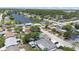 Aerial view showcasing a home near a lake and surrounding neighborhood at 7330 Abalone Dr, Port Richey, FL 34668