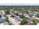 Panoramic aerial view of a neighborhood with tree-lined streets and well-maintained homes at 7330 Abalone Dr, Port Richey, FL 34668