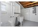 Finished basement featuring a wash basin, utility room, and a partial bathroom at 7330 Abalone Dr, Port Richey, FL 34668