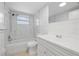 Updated bathroom with marble tiled walls, modern fixtures, and a shower-tub combination at 7330 Abalone Dr, Port Richey, FL 34668