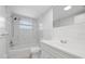 Clean bathroom featuring tiled shower and bathtub, toilet, and vanity with sink at 7330 Abalone Dr, Port Richey, FL 34668