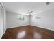 Comfortable bedroom with hardwood floors, a modern ceiling fan, and natural light at 7330 Abalone Dr, Port Richey, FL 34668