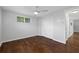 Bedroom with hardwood floors, ceiling fan, closet, and natural light from the window at 7330 Abalone Dr, Port Richey, FL 34668