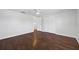Bright bedroom featuring hardwood floors, closet, and ceiling fan at 7330 Abalone Dr, Port Richey, FL 34668
