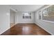 Bright dining room featuring hardwood floors and abundant natural light from large windows at 7330 Abalone Dr, Port Richey, FL 34668