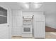 Well-lit kitchen featuring white appliances, tile floors, and ample cabinet space at 7330 Abalone Dr, Port Richey, FL 34668