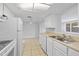 Bright kitchen featuring stainless steel sink, modern appliances, and ample storage at 7330 Abalone Dr, Port Richey, FL 34668