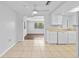 Bright kitchen features tile floor, white cabinets, and a seamless connection to the adjacent dining area at 7330 Abalone Dr, Port Richey, FL 34668