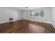 The living room features hardwood floors, a front door and large front window at 7330 Abalone Dr, Port Richey, FL 34668