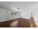Inviting living room with hardwood floors, natural light, and neutral wall color at 7330 Abalone Dr, Port Richey, FL 34668