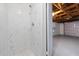 Modern shower stall with white marble tile, rainfall shower head, and an open view to the garage at 7330 Abalone Dr, Port Richey, FL 34668