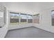 Bright sun room with multiple windows and a painted concrete floor with easy outdoor access at 7330 Abalone Dr, Port Richey, FL 34668