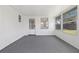Enclosed sunroom featuring multiple windows and door that offers outdoor views at 7330 Abalone Dr, Port Richey, FL 34668