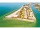 Stunning aerial view of a coastal community with pristine beaches and clear blue waters at 7564 Bayshore Dr # 202, Treasure Island, FL 33706