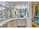 Large bathroom with nautical themed mirror, plenty of countertop space and shower/tub combo is ready for your personal touch at 7564 Bayshore Dr # 202, Treasure Island, FL 33706