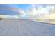 Serene beach with soft sand and peaceful ocean views under a beautiful sky at 7564 Bayshore Dr # 202, Treasure Island, FL 33706