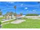Beautiful beach view with white sand, palm trees, and a charming gazebo under a sunny blue sky at 7564 Bayshore Dr # 202, Treasure Island, FL 33706