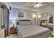 Serene bedroom featuring wood-look flooring, ceiling fan, and a mirrored closet for additional space and comfort at 7564 Bayshore Dr # 202, Treasure Island, FL 33706