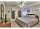 Relax in this bedroom with a calming color scheme, wood-look flooring, and a ceiling fan for a comfortable ambiance at 7564 Bayshore Dr # 202, Treasure Island, FL 33706