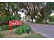 Charming entrance to Land's End with lush greenery and a welcoming brick pathway at 7564 Bayshore Dr # 202, Treasure Island, FL 33706