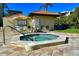 Enjoy the Florida sunshine in this community hot tub with umbrella-covered seating for a relaxing outdoor experience at 7564 Bayshore Dr # 202, Treasure Island, FL 33706