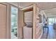 A convenient stacked washer and dryer inside a closet featuring weathered wood accents are ready to make chores a breeze at 7564 Bayshore Dr # 202, Treasure Island, FL 33706