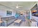 Spacious living room with comfortable seating and a captivating flamingo-themed accent wall at 7564 Bayshore Dr # 202, Treasure Island, FL 33706