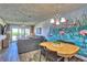 Open-concept living and dining area with access to a scenic balcony at 7564 Bayshore Dr # 202, Treasure Island, FL 33706