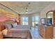 Enjoy waking up in this main bedroom, featuring a tropical mural and access to a private balcony with ocean views at 7564 Bayshore Dr # 202, Treasure Island, FL 33706