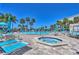 Relax by the pool or unwind in the hot tub surrounded by lush landscaping and resort-style amenities at 7564 Bayshore Dr # 202, Treasure Island, FL 33706