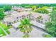 Scenic aerial view of the condo complex with covered parking and palm trees at 7823 Hardwick Dr # 224, New Port Richey, FL 34653