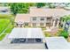 Aerial view of the two story condo with carports, landscaping, and nearby parking at 7823 Hardwick Dr # 224, New Port Richey, FL 34653