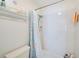 Bright bathroom features a shower with white tiles and colorful shower curtain at 7823 Hardwick Dr # 224, New Port Richey, FL 34653