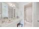Bright bathroom features a vanity, a large mirror, and a tiled shower at 7823 Hardwick Dr # 224, New Port Richey, FL 34653