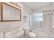 Bright bathroom featuring a vanity, toilet, and shower over tub with glass doors at 7823 Hardwick Dr # 224, New Port Richey, FL 34653