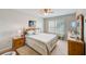 Bedroom featuring a comfortable bed, shuttered windows, and ample natural light at 7823 Hardwick Dr # 224, New Port Richey, FL 34653