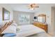 Bright bedroom featuring a comfortable bed, shuttered windows, and wood furniture at 7823 Hardwick Dr # 224, New Port Richey, FL 34653