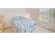 Cozy bedroom with a comfortable bed and bright natural light from the window at 7823 Hardwick Dr # 224, New Port Richey, FL 34653