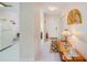 Bright hallway featuring tile flooring and access to the kitchen, bathroom, and living areas at 7823 Hardwick Dr # 224, New Port Richey, FL 34653
