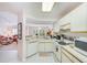 Well-lit kitchen offering white appliances, tile floors, and an open floorplan at 7823 Hardwick Dr # 224, New Port Richey, FL 34653