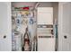 Functional laundry closet featuring a stacked washer and dryer, as well as organized shelving at 7823 Hardwick Dr # 224, New Port Richey, FL 34653