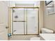 Bathroom showcasing a gold-framed sliding glass shower door and a toilet at 814 Cape Cod Cir, Valrico, FL 33594