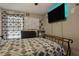 Cozy bedroom features patterned bedding, and a mounted TV at 814 Cape Cod Cir, Valrico, FL 33594