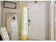 The home's bright foyer features a white door, mirror, and a 'Gathering Together Forever' sign at 814 Cape Cod Cir, Valrico, FL 33594