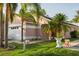 Charming single-Gathering home with a well-maintained lawn and beautiful palm trees, creating a tropical oasis at 814 Cape Cod Cir, Valrico, FL 33594