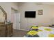 A main bedroom features bright bedding and a TV on the wall at 814 Cape Cod Cir, Valrico, FL 33594